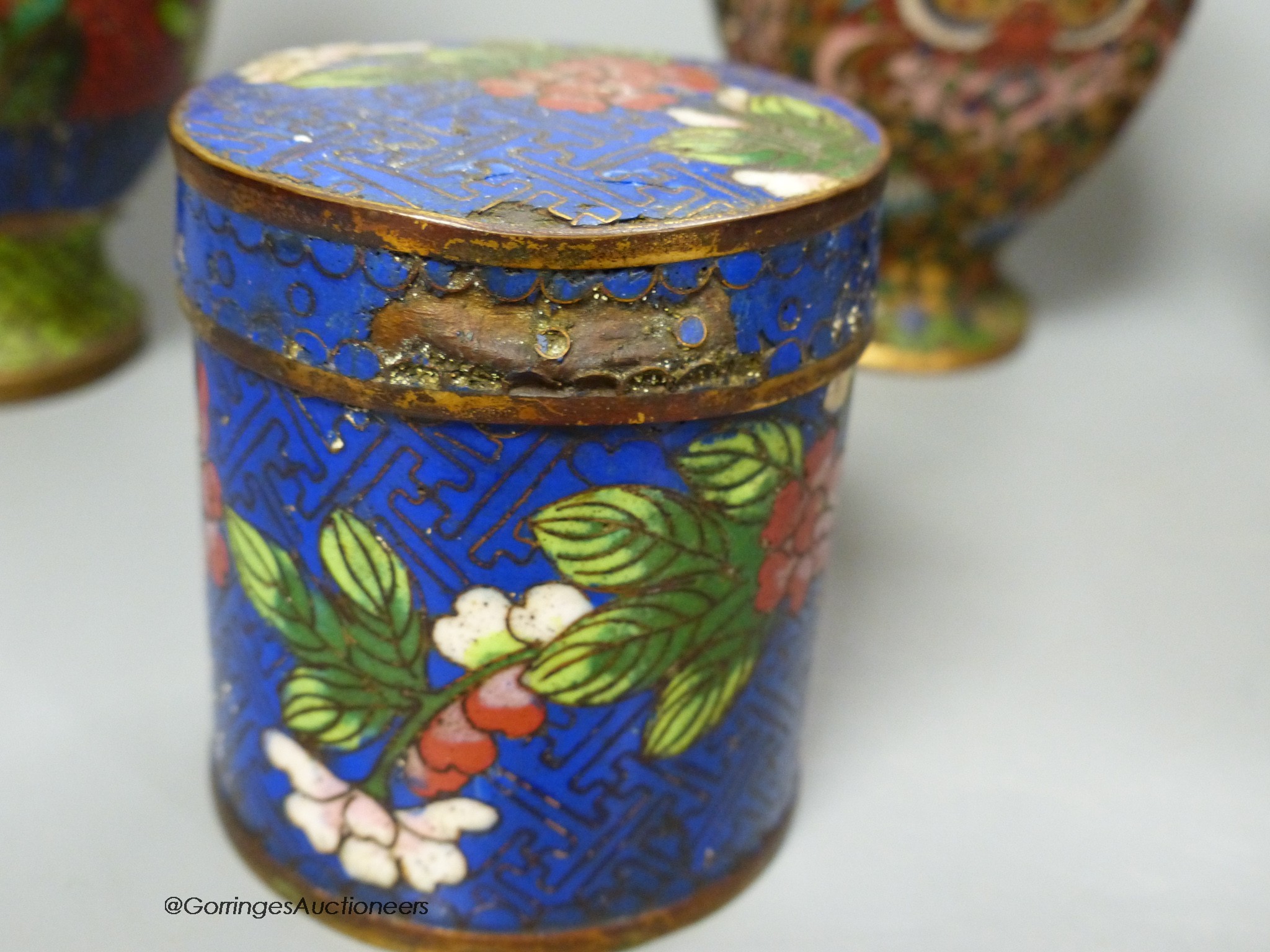 A pair of Chinese gilt ground cloisonné enamel vases, 16cm high a similar jar and cover